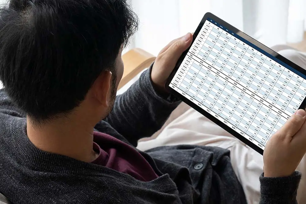man checking schedule on a tablet