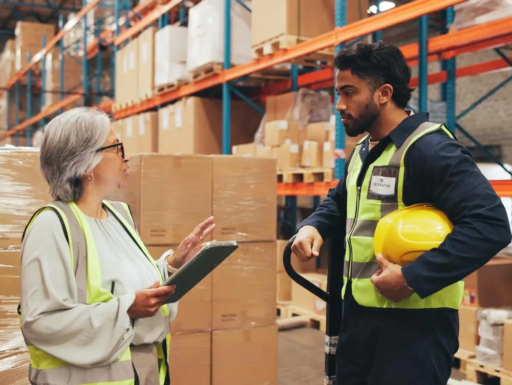 business central warehouse management | warehouse workers discussing orders